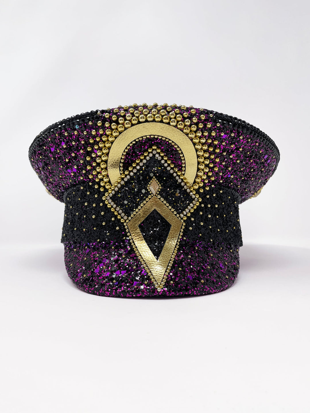Hand embellished captain hat crafted from an authentic military hat, decorated with black and purple glitter, gold pearl like gems, rhinestones, crystals and geometric jewel detailing. Luxury stage, festival and statement fashion headwear. Handmade, rave, fully lined, high end fashion, costume hat