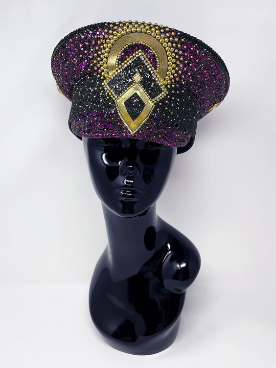 Hand embellished captain hat crafted from an authentic military hat, decorated with black and purple glitter, gold pearl like gems, rhinestones, crystals and geometric jewel detailing. Luxury stage, festival and statement fashion headwear. Handmade, rave, fully lined, high end fashion, costume hat