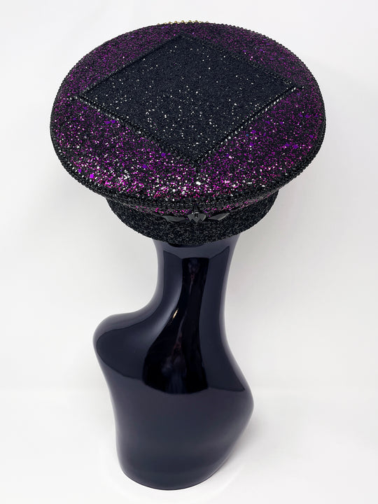 Hand embellished captain hat crafted from an authentic military hat, decorated with black and purple glitter, gold pearl like gems, rhinestones, crystals and geometric jewel detailing. Luxury stage, festival and statement fashion headwear. Handmade, rave, fully lined, high end fashion, costume hat