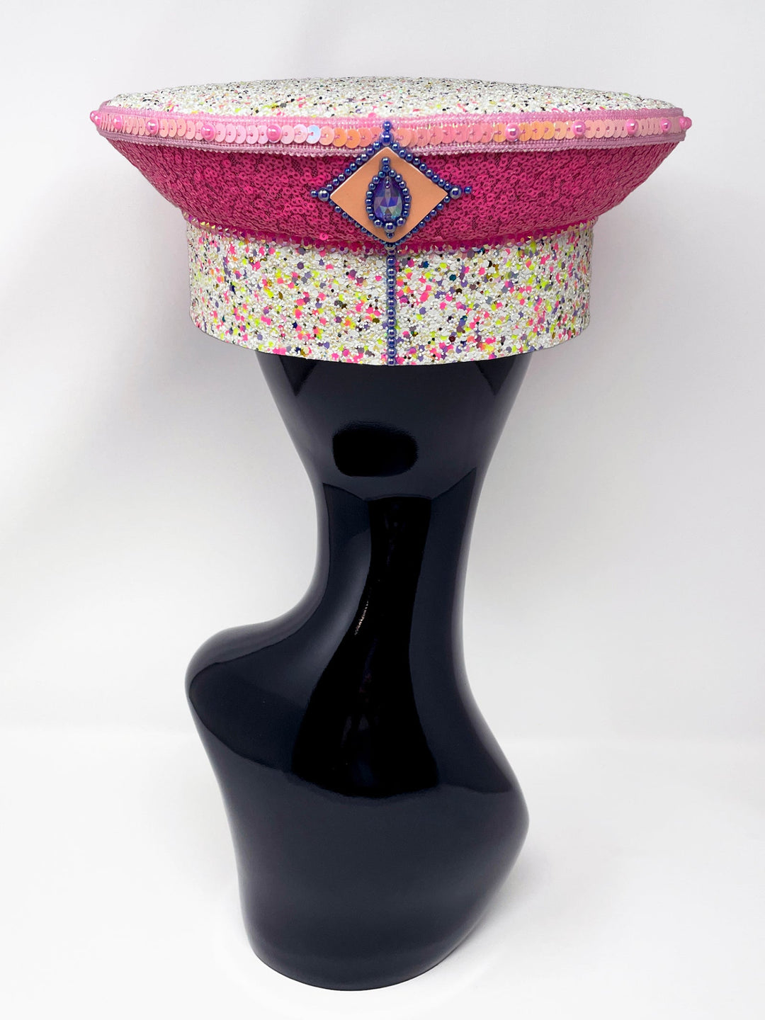 Festival captain hat with pink sequins, colourful glitter peak, Jukebox logo jewel detail, and glow-in-the-dark reflective starburst design – perfect for rave, costume, or party wear. Festival 
fashion,, stage wear