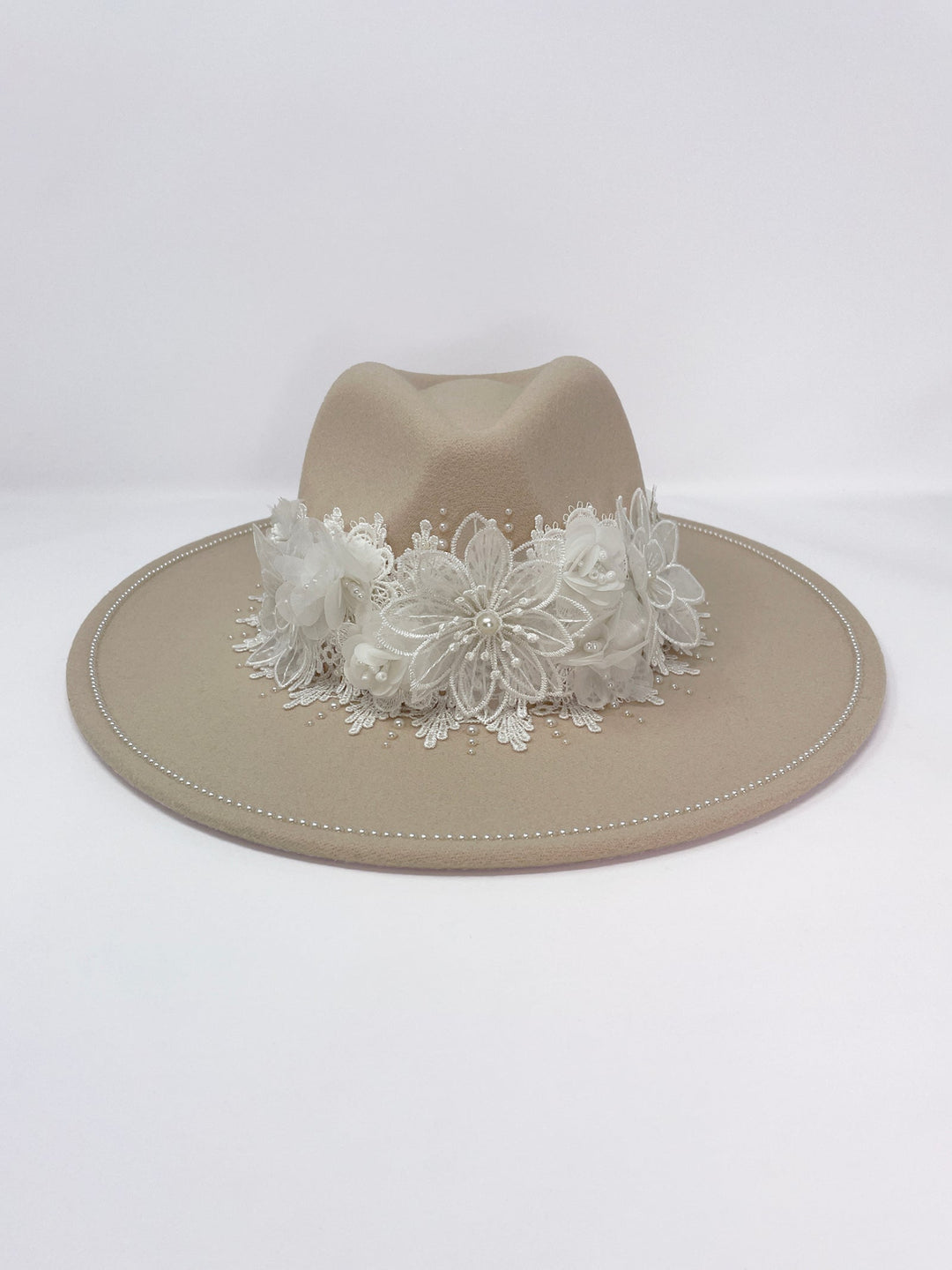 Beige fedora hat featuring interchangeable handmade lace bands with Velcro attachments. Includes three designs: “BRIDE” and “WIFEY” lettering embellished with crystals and pearls, and an elegant floral motif with lace, handmade  flowers and beaded details. A stylish 3-in-1 bridal accessory made in the UK. One size, wide brim fedora, luxury fedora, bride hat, wifey hat, floral hat, hen do