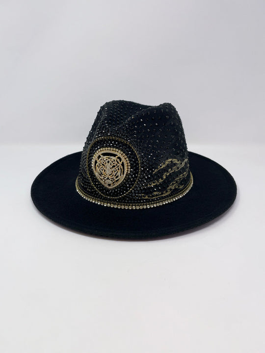 Short brim black fedora with black and metallic gold hand painted tiger print. Gold tiger motive centrepiece and crystal embellishments. Luxury fedora, rhinestones, statement fedora, unique headwear, animal print
