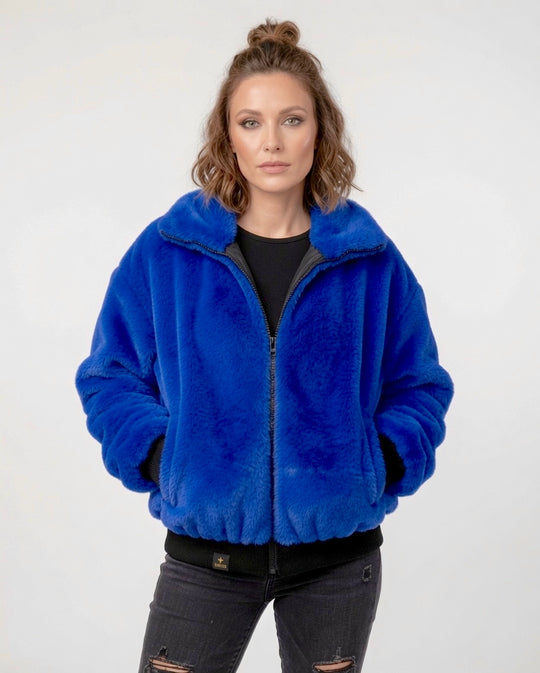 Handmade electric blue faux fur bomber jacket with colourful sequin Hamsa hand appliqué on the back, black sequin V detailing, soft collar, black ribbed cuff and waistband, front zip fastening and side pockets. Festival coat, party jacket, royal blue