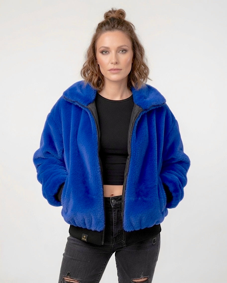 Handmade electric blue faux fur bomber jacket with colourful sequin Hamsa hand appliqué on the back, black sequin V detailing, soft collar, black ribbed cuff and waistband, front zip fastening and side pockets. Festival coat, party jacket, royal blue