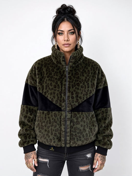 Forest green leopard print faux fur bomber jacket with contrasting black panels, oversized collar, front zip fastening, pockets and ribbed cuffs and ribbed waistband. Modelled with black ripped jeans. Plush faux fur, festival jacket, winter coat