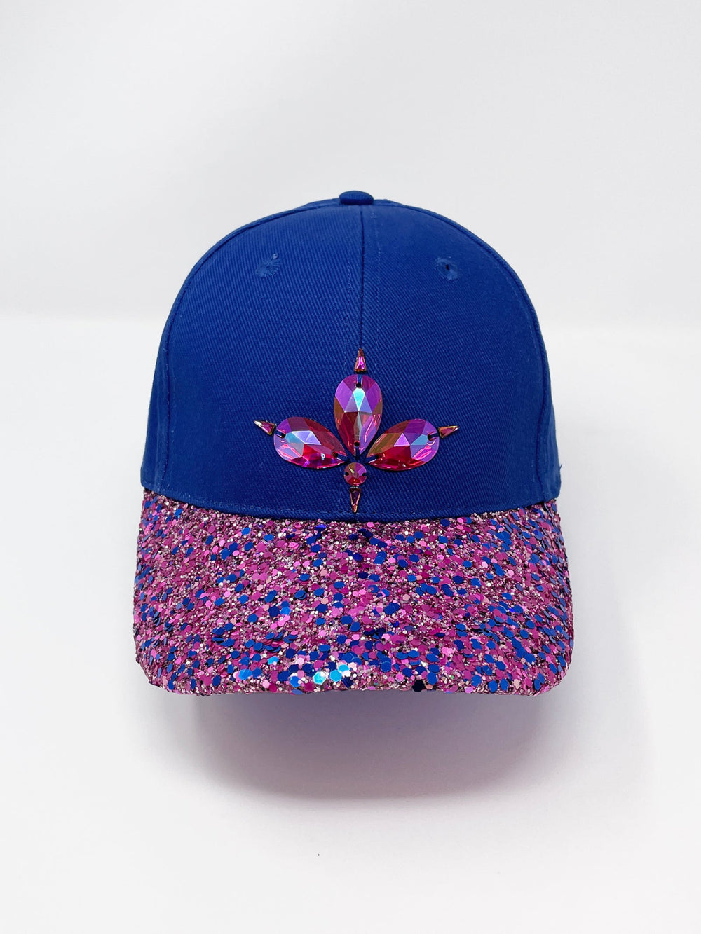 Blue curved peak cap with an embellished vibrant pink and blue glitter mix peak and 3D Jukebox logo emblem centre front, stylish streetwear, eye catching accessory, adjustable, velcro back, party hat, festival hat, urban, unique headwear, made in the UK