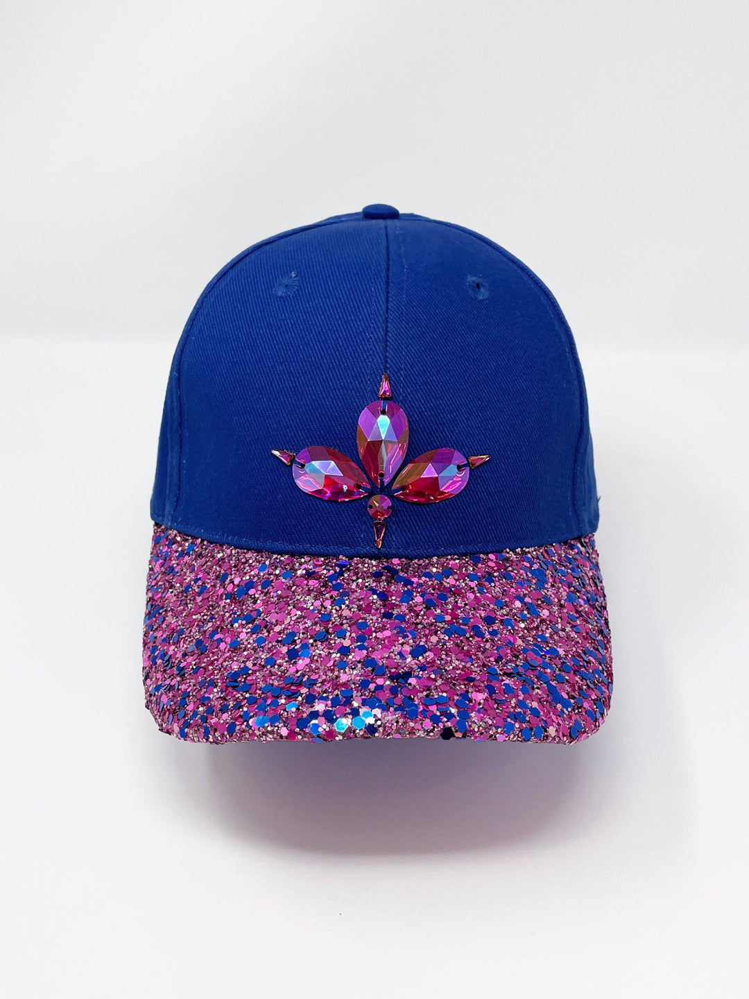 Blue curved peak cap with an embellished vibrant pink and blue glitter mix peak and 3D Jukebox logo emblem centre front, stylish streetwear, eye catching accessory, adjustable, velcro back, party hat, festival hat, urban, unique headwear, made in the UK