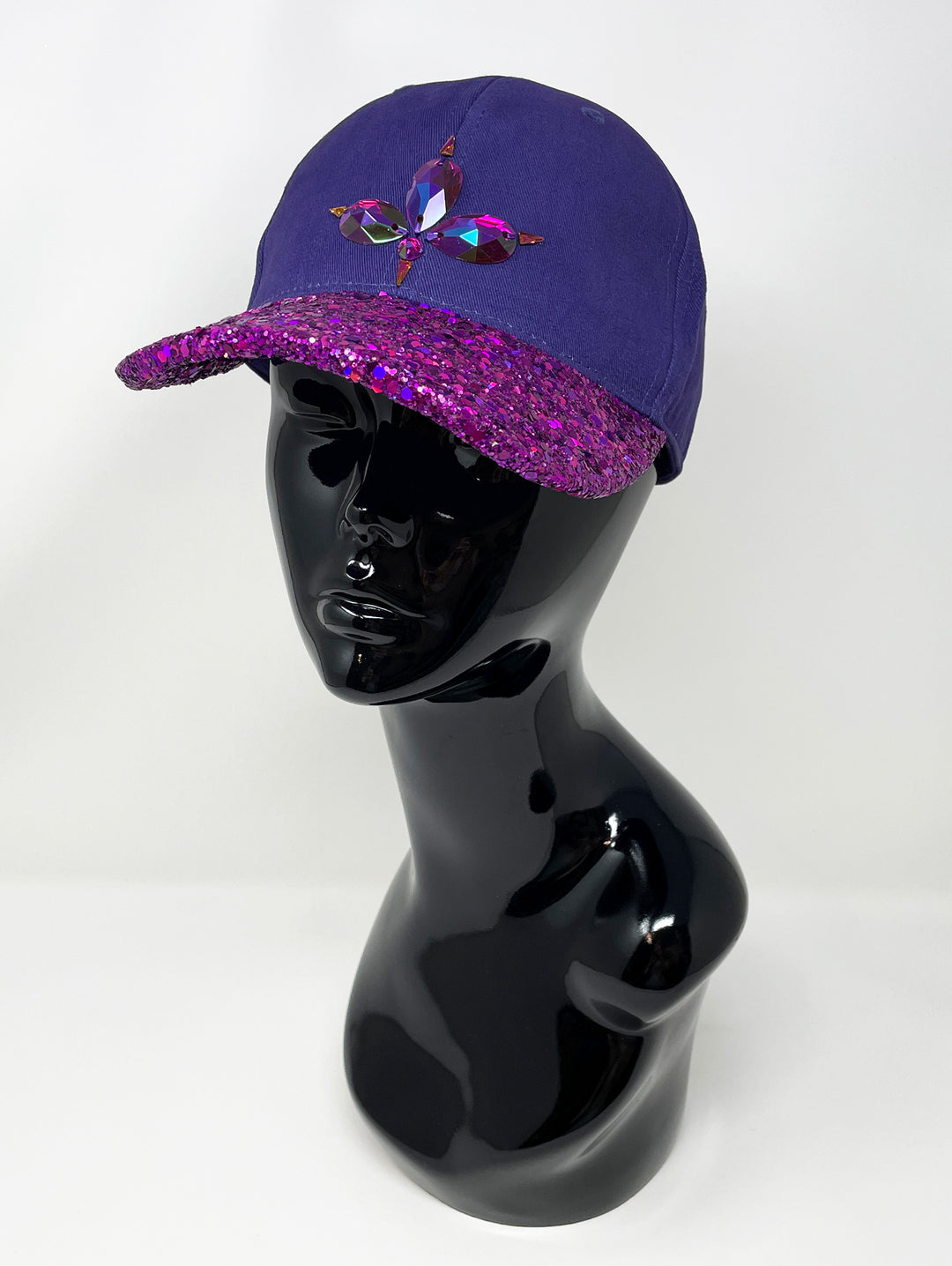 Purple curved peak cap with an embellished vibrant pink glitter mix peak and 3D Jukebox logo emblem centre front, stylish streetwear, eye catching accessory, adjustable, buckle back, party hat, festival hat, urban, unique headwear, made in the UK