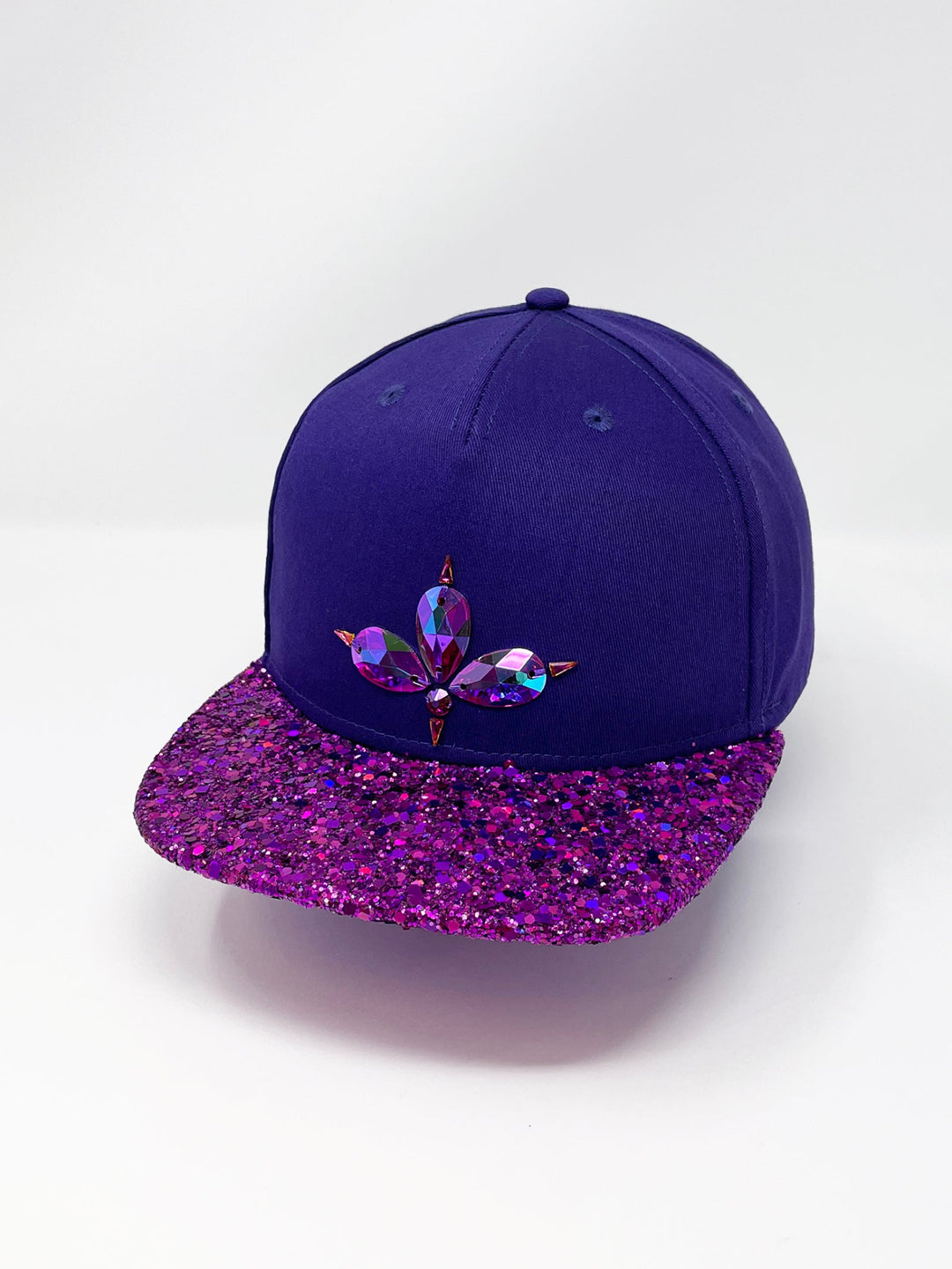 Purple flat peak cap with a vibrant pink chunky glitter peak. 3D Jukebox logo emblem centre front, stylish streetwear, eye catching accessory, adjustable, snapback, party hat, festival hat, rave, urban, crystals, festival fashion, glow, rhinestones, unique headwear, made in the UK