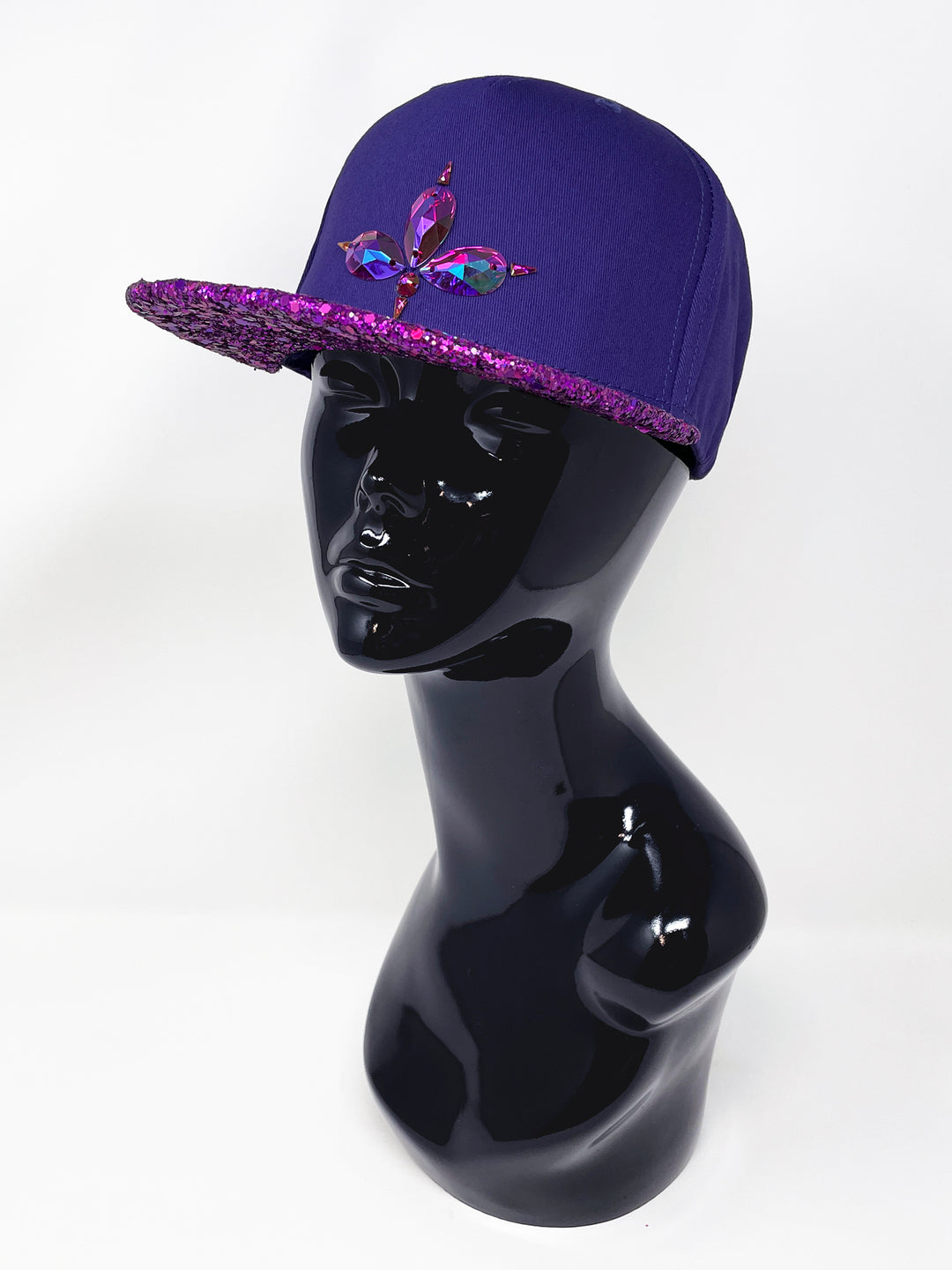 Purple flat peak cap with a vibrant pink chunky glitter peak. 3D Jukebox logo emblem centre front, stylish streetwear, eye catching accessory, adjustable, snapback, party hat, festival hat, rave, urban, crystals, festival fashion, glow, rhinestones, unique headwear, made in the UK