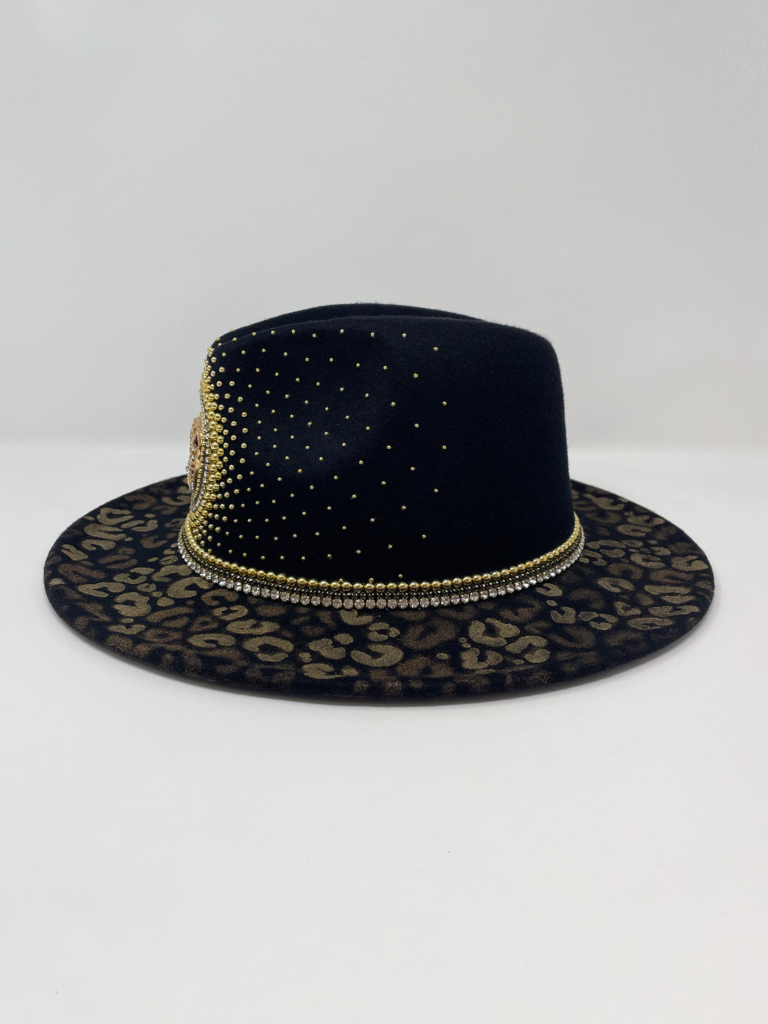 Short Brim black fedora hat, hand painted leopard print in metallic gold tones, with a gold metal and crystal leopard centre motif, embellished with gold pearl like rhinestones and crystals. gold splash, luxury fedora, made in the uk, handmade, statement hat, high end fashion, festival fedora, ibiza hat