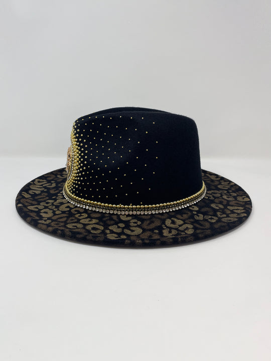 Short Brim black fedora hat, hand painted leopard print in metallic gold tones, with a gold metal and crystal leopard centre motif, embellished with gold pearl like rhinestones and crystals. gold splash, luxury fedora, made in the uk, handmade, statement hat, high end fashion, festival fedora, ibiza hat