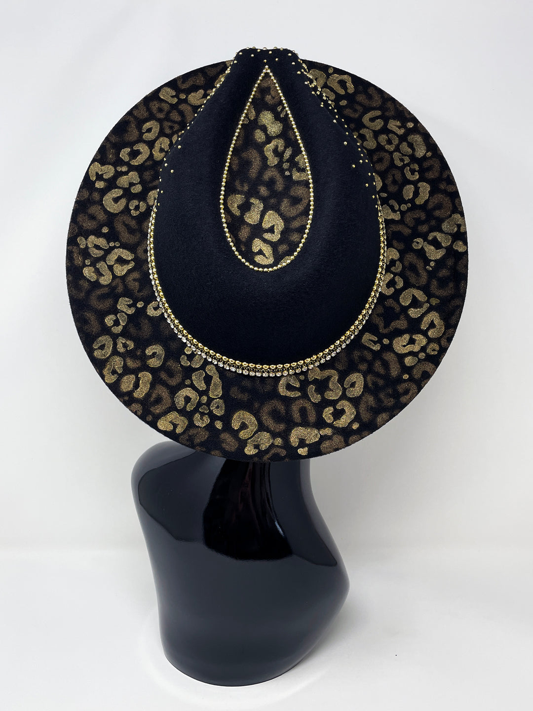 Short Brim black fedora hat, hand painted leopard print in metallic gold tones, with a gold metal and crystal leopard centre motif, embellished with gold pearl like rhinestones and crystals. gold splash, luxury fedora, made in the uk, handmade, statement hat, high end fashion, festival fedora, ibiza hat
