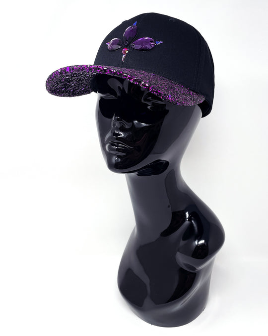 Black curved peak cap with purple and black glitter mix peak. 3D Jukebox logo emblem centre front, stylish streetwear, eye catching accessory, adjustable, snapback, party hat, halloween, festival hat, urban, crystals, rhinestones, unique headwear, made in the UK