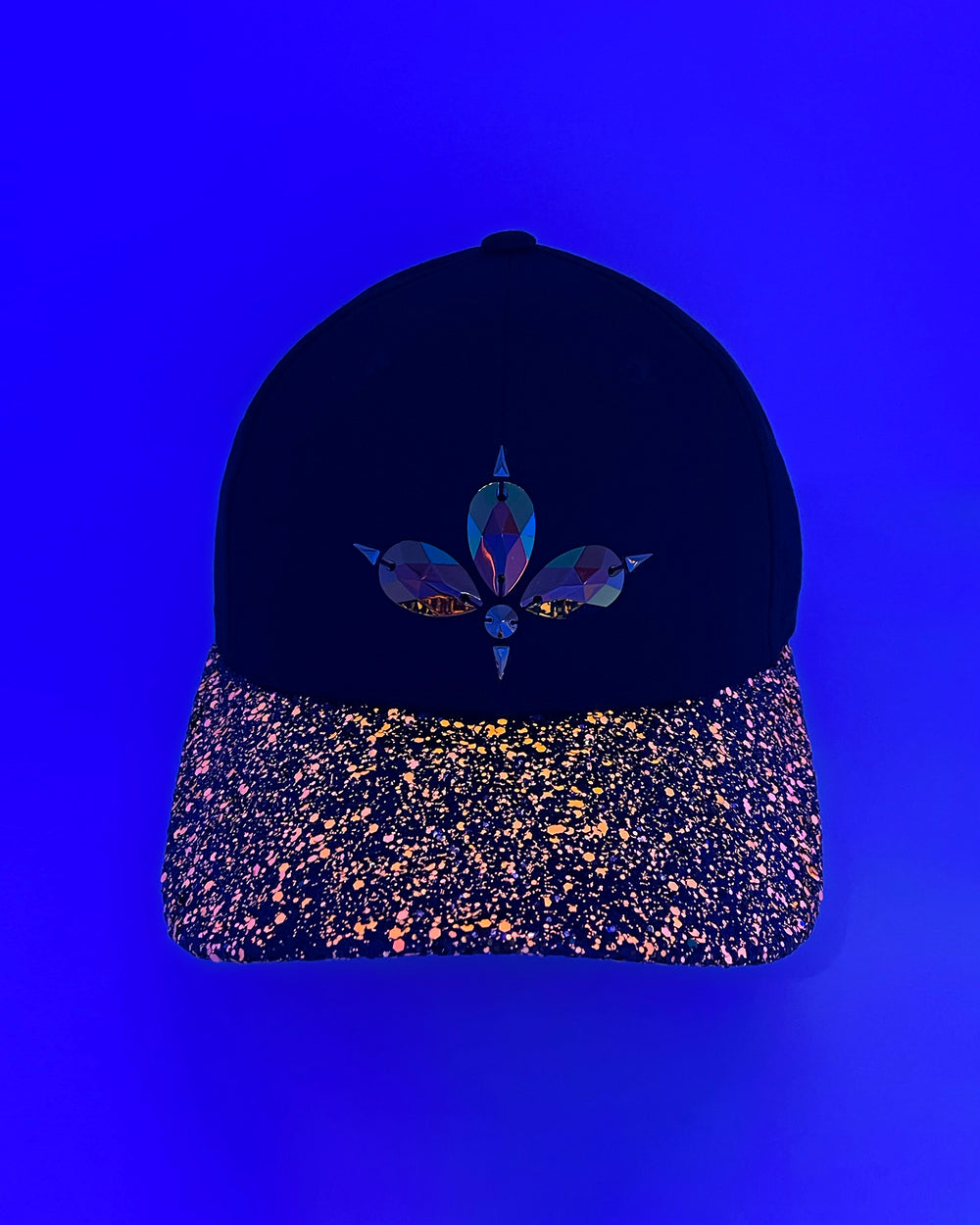 Black curved peak cap with neon UV orange and black glitter mix peak. 3D Jukebox logo emblem centre front, stylish streetwear, eye catching accessory, adjustable, snapback, party hat, glow, festival hat, urban, crystals, rhinestones, unique headwear, made in the UK