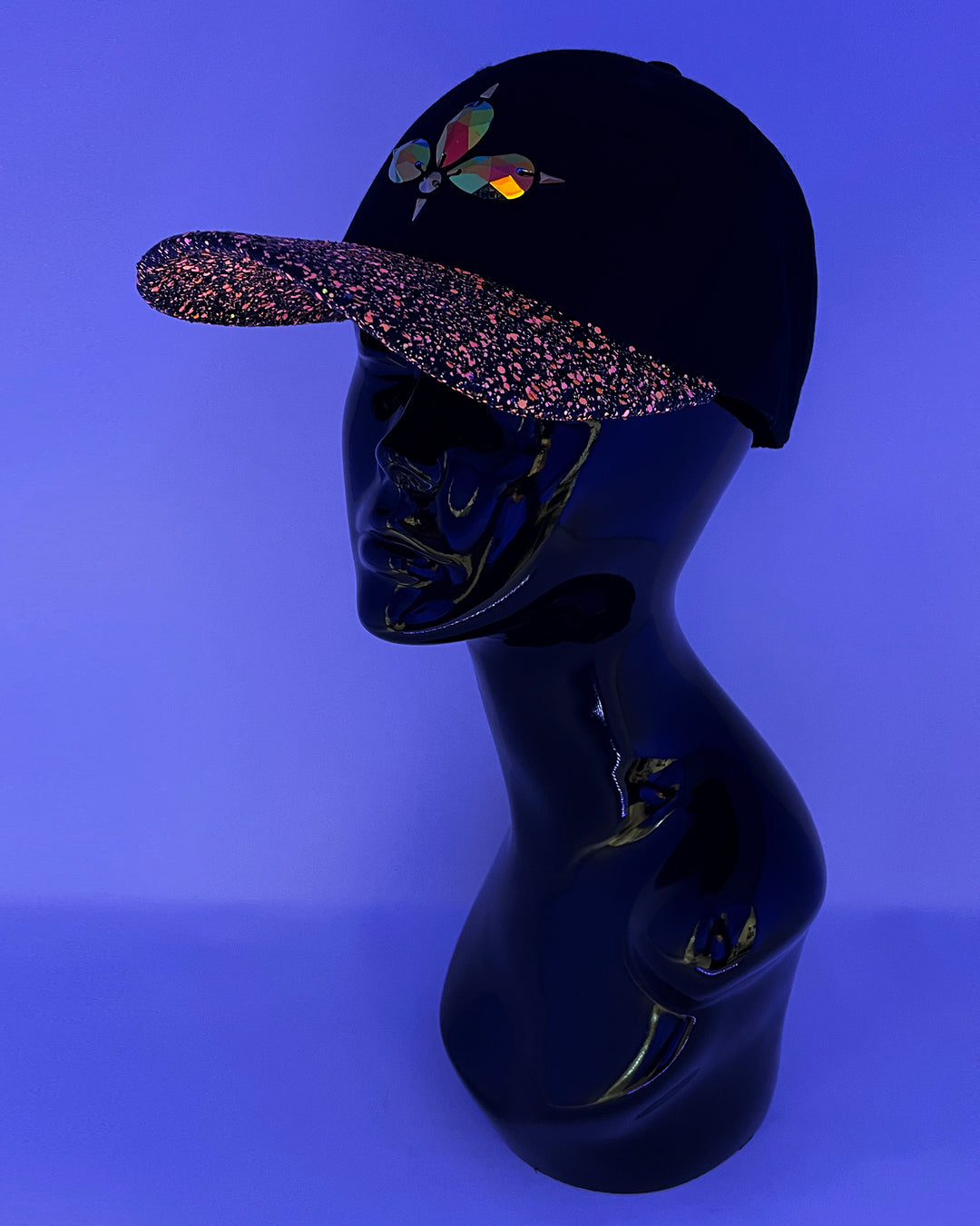 Black curved peak cap with neon UV orange and black glitter mix peak. 3D Jukebox logo emblem centre front, stylish streetwear, eye catching accessory, adjustable, snapback, party hat, glow, festival hat, urban, crystals, rhinestones, unique headwear, made in the UK