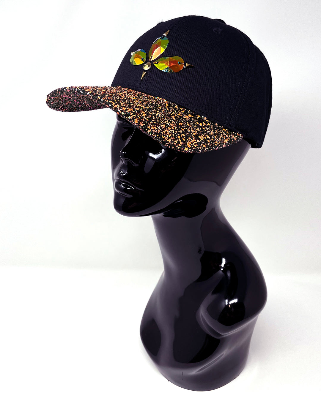 Black curved peak cap with neon UV orange and black glitter mix peak. 3D Jukebox logo emblem centre front, stylish streetwear, eye catching accessory, adjustable, snapback, party hat, glow, festival hat, urban, crystals, rhinestones, unique headwear, made in the UK