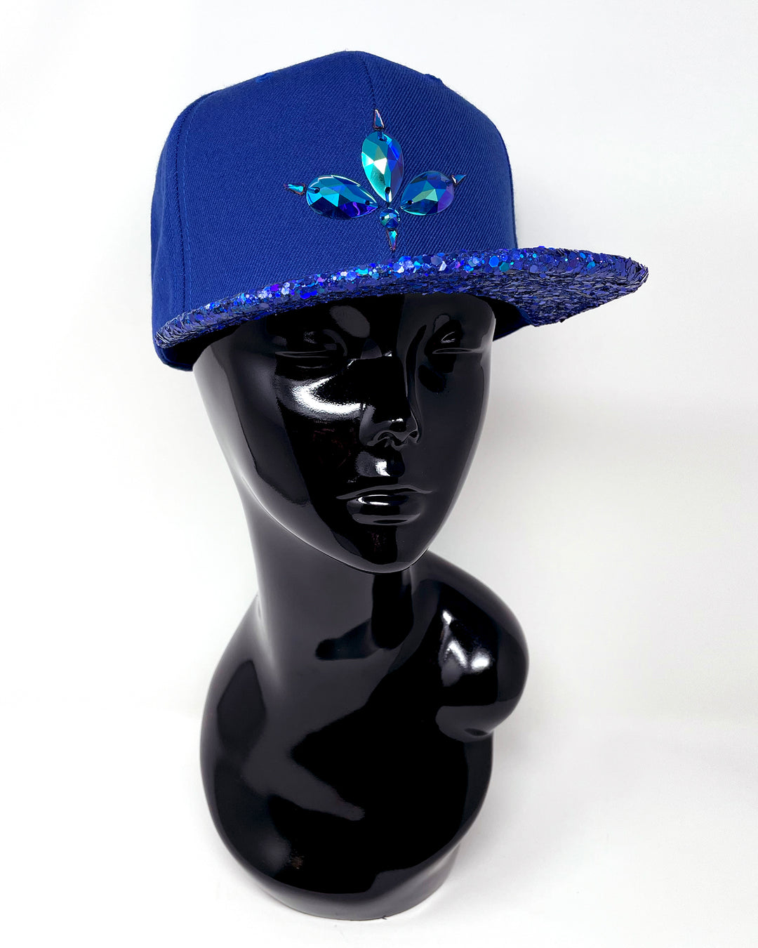 Blue flat peak cap with a blue chunky glitter peak. 3D Jukebox logo emblem centre front, stylish streetwear, eye catching accessory, adjustable, snapback, party hat, festival hat, rave, urban, crystals, Royal blue, electric blue, festival fashion, glow, rhinestones, unique headwear, made in the UK