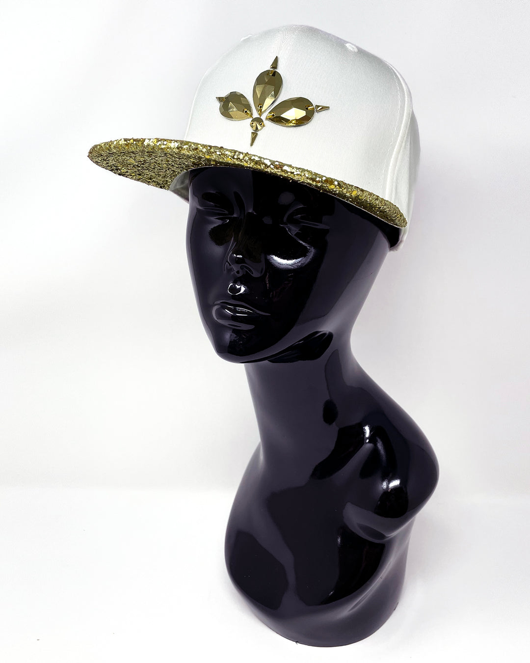 White flat peak cap with a metallic gold glitter peak. 3D Jukebox logo emblem centre front, stylish streetwear, eye catching accessory, adjustable, snapback, party hat, festival hat, rave, urban, crystals, Halloween, festival fashion, rhinestones, unique headwear, made in the UK