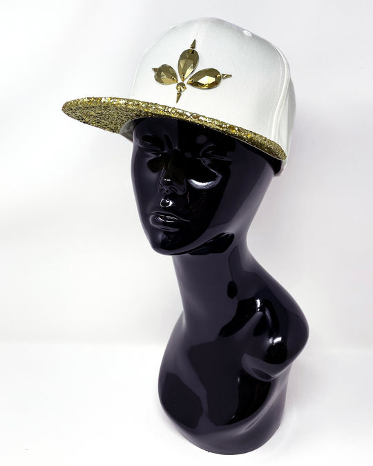 White flat peak cap with a metallic gold glitter peak. 3D Jukebox logo emblem centre front, stylish streetwear, eye catching accessory, adjustable, snapback, party hat, festival hat, rave, urban, crystals, Halloween, festival fashion, rhinestones, unique headwear, made in the UK