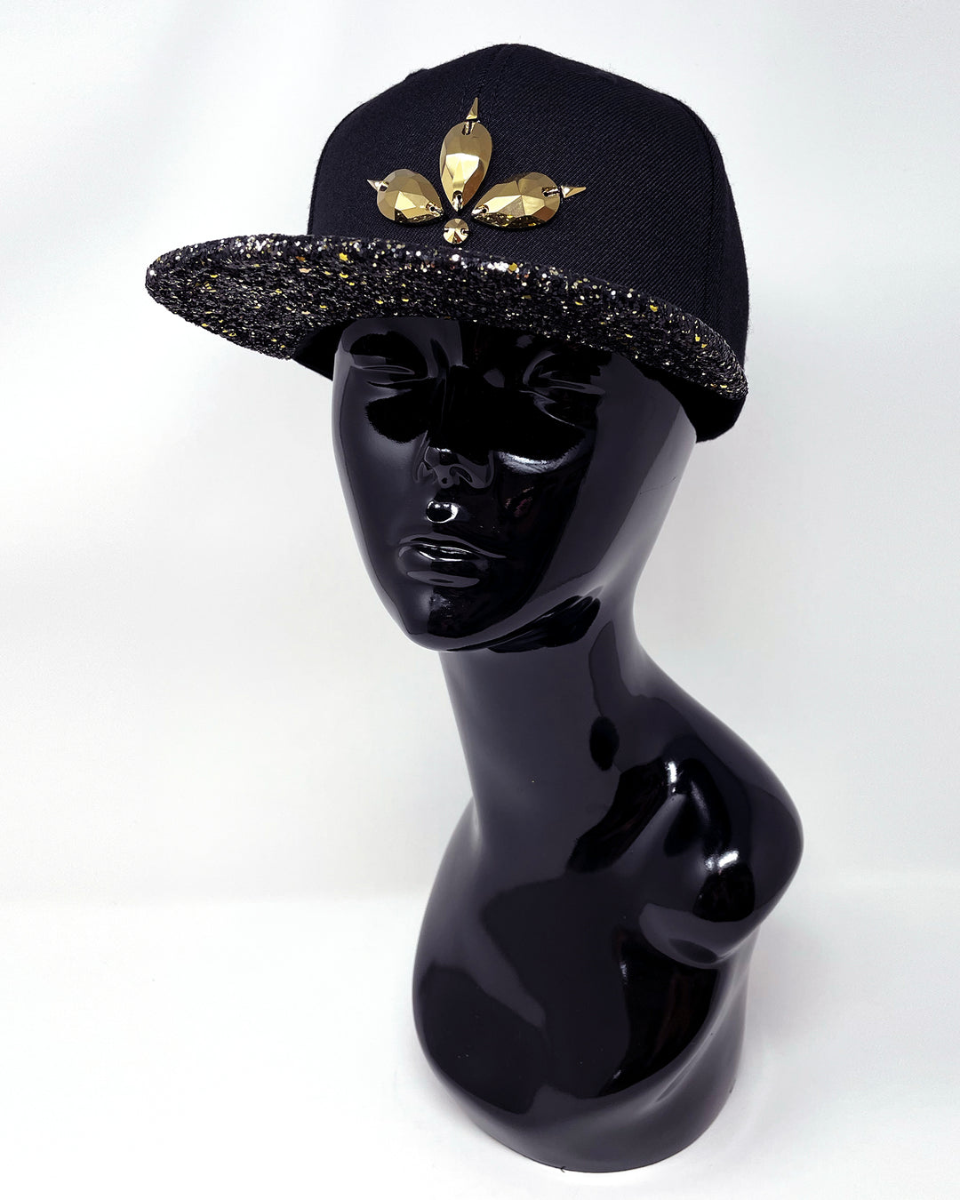 Black flat peak cap with a gold and black glitter mix peak. 3D Jukebox logo emblem centre front, stylish streetwear, eye catching accessory, adjustable, snapback, party hat, festival hat, rave, urban, crystals, Halloween, festival fashion, rhinestones, unique headwear, made in the UK