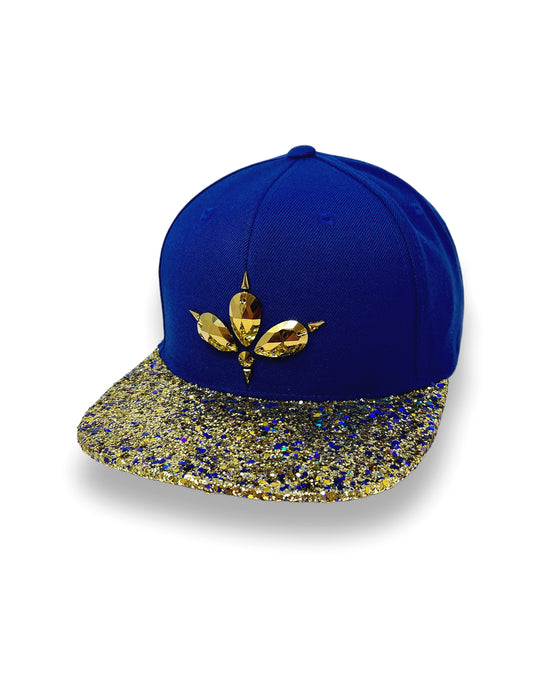 Blue flat peak cap with a gold and blue glitter mix peak. 3D Jukebox logo emblem centre front, stylish streetwear, eye catching accessory, adjustable, snapback, party hat, festival hat, rave, urban, crystals, Royal blue, festival fashion, rhinestones, unique headwear, made in the UK